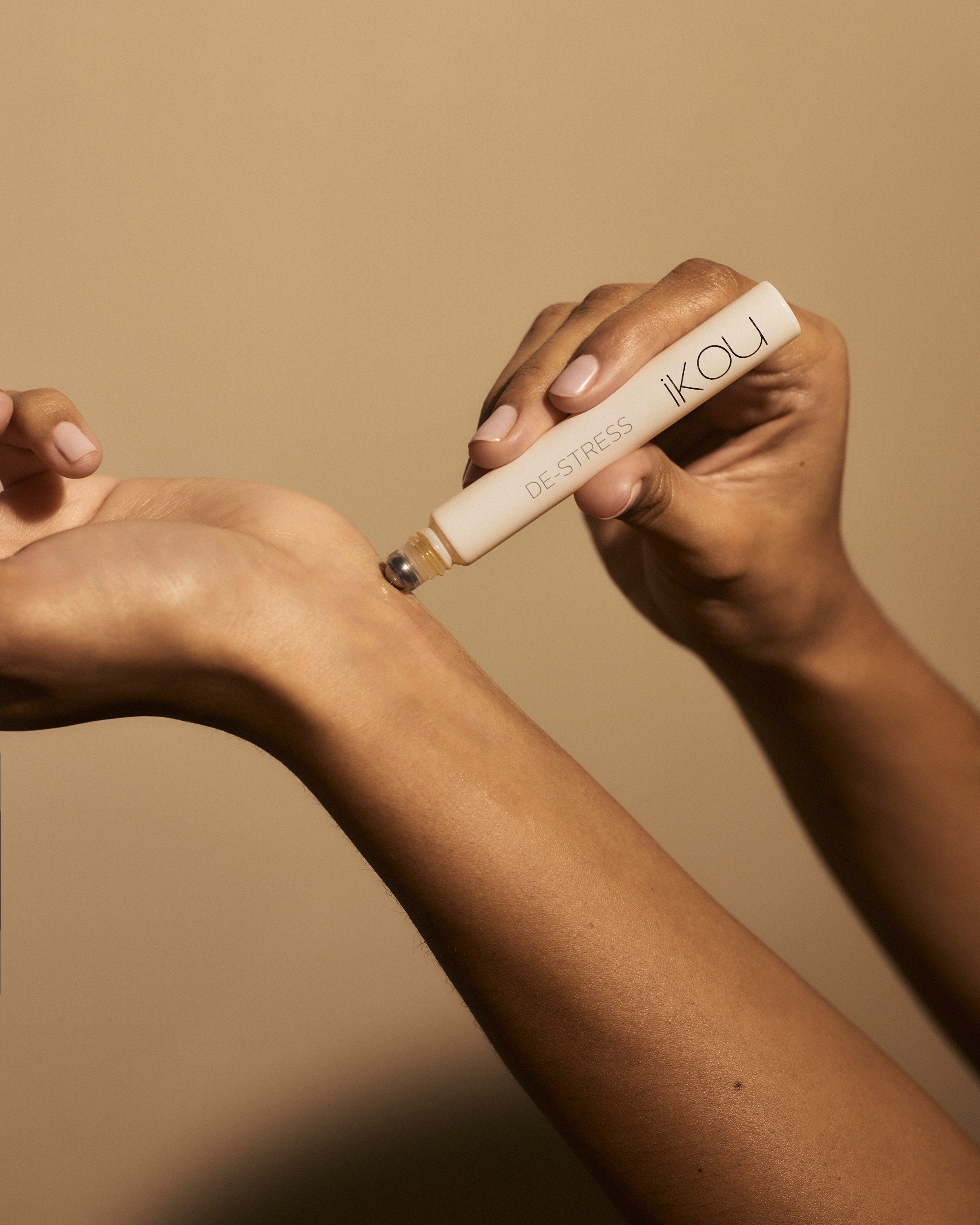 Hands applying a De-Stress Aromatherapy rollon r