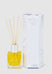 Diffuser bottle with reeds and packaging on a light gray background