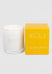 White candle in a clear glass holder next to a yellow box labeled 'KOU Golden Hour' on a light gray background