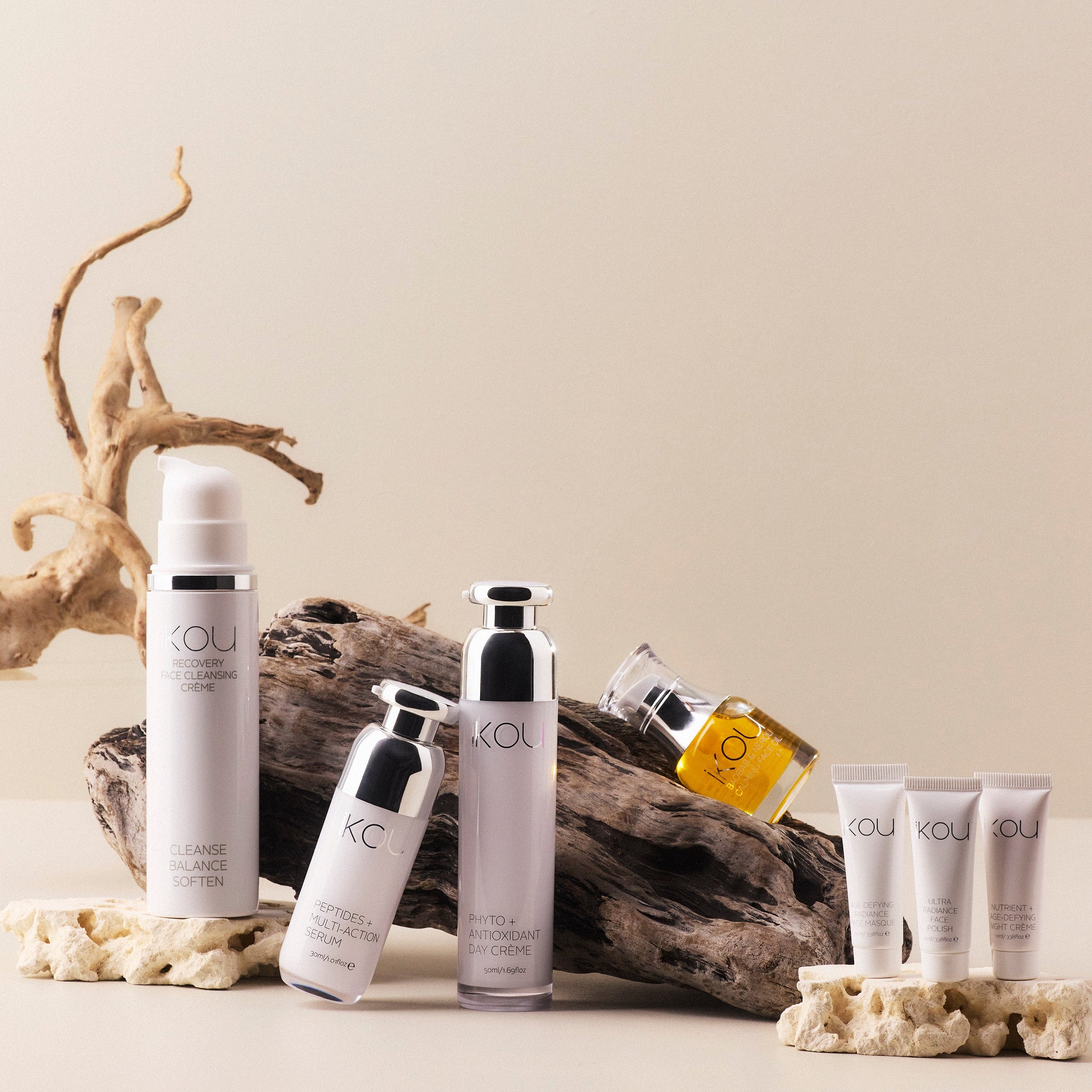 Skincare products with 'IKOU' branding on a neutral background