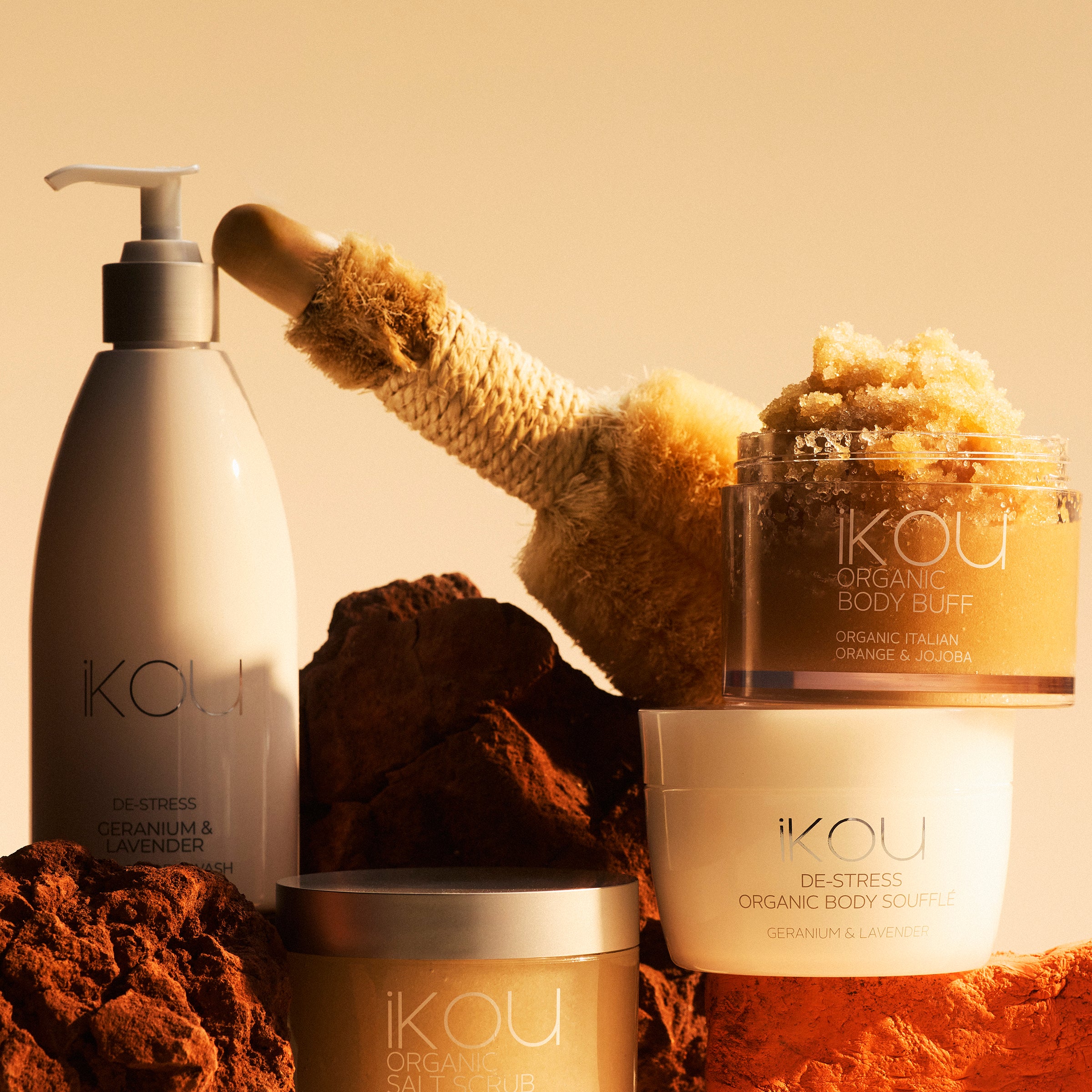 Ikou skincare products including a bottle, jar, and scrub on a beige background