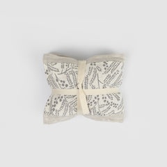 Heat pack  with floral pattern tied together on a  grey background
