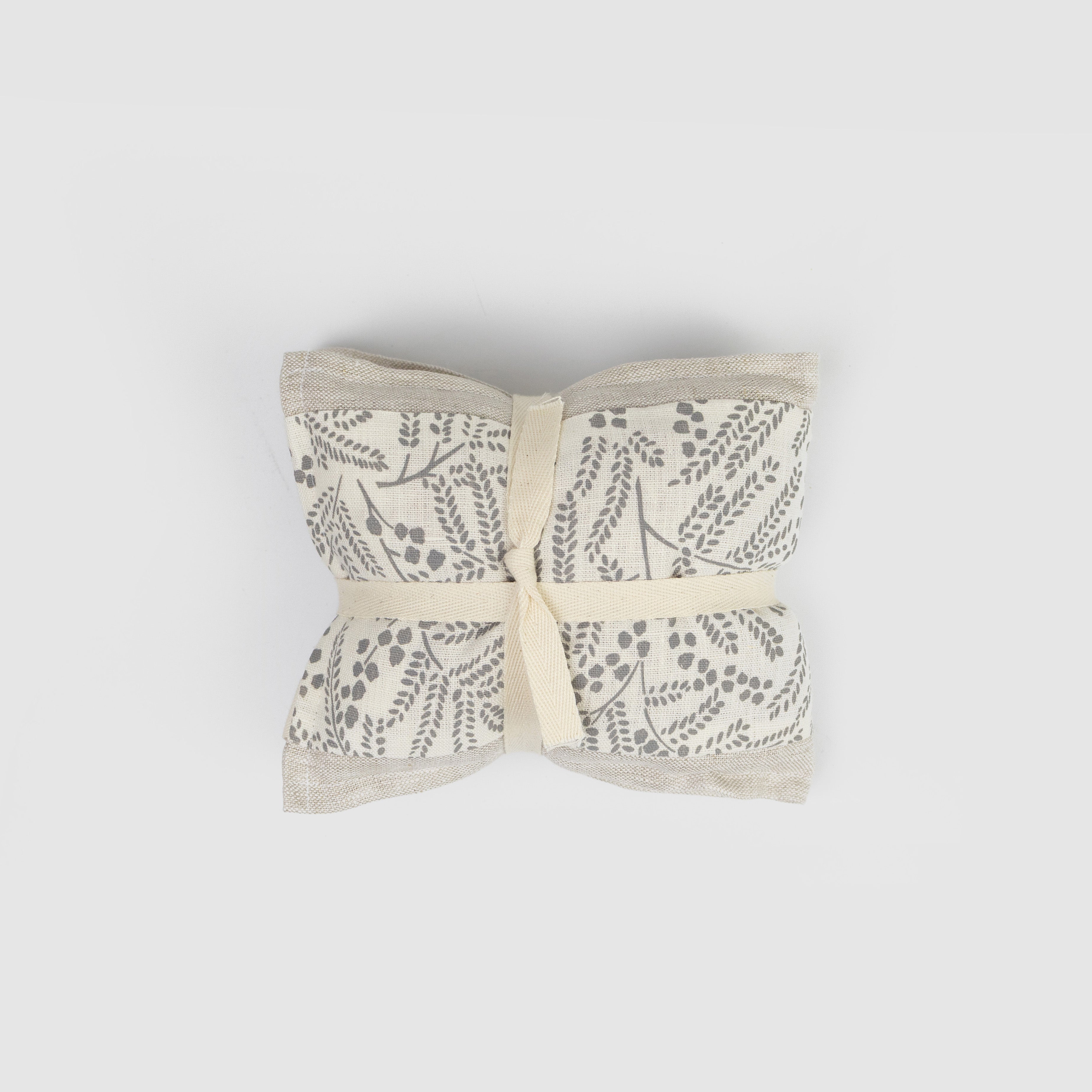 Heat pack  with floral pattern tied together on a  grey background