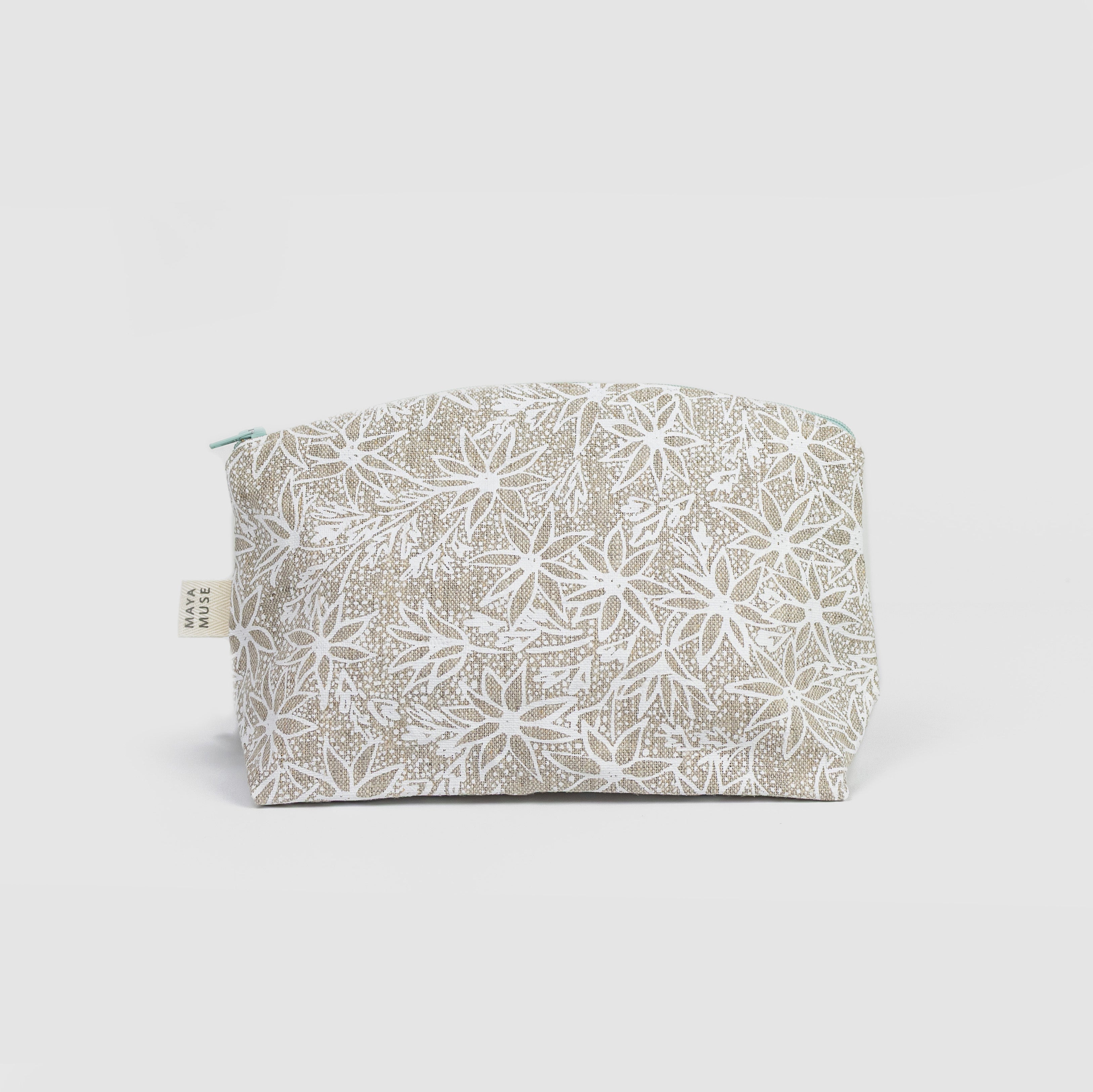 Fabric pouch with floral pattern on a light grey background