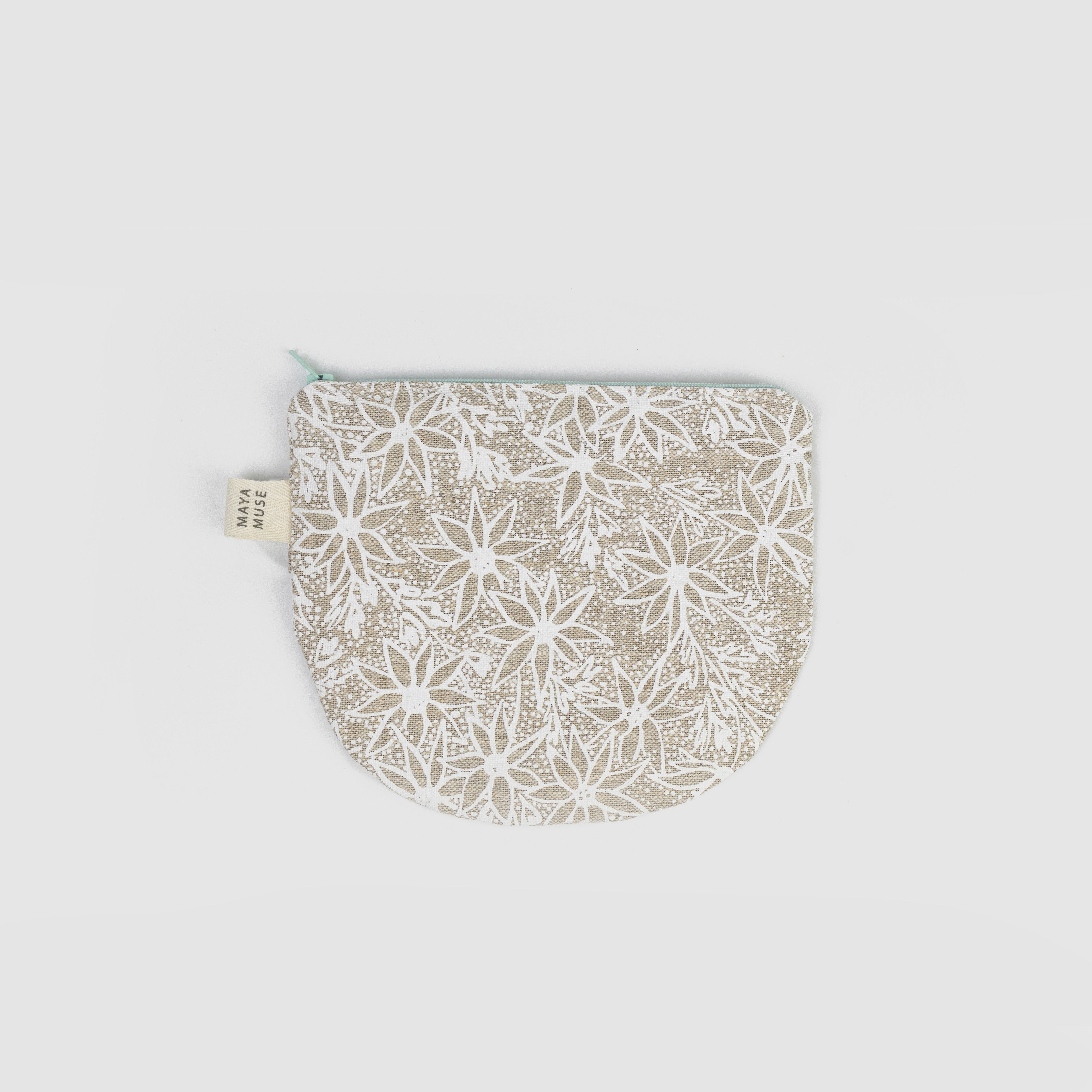 Fabric pouch with floral pattern on a light grey background