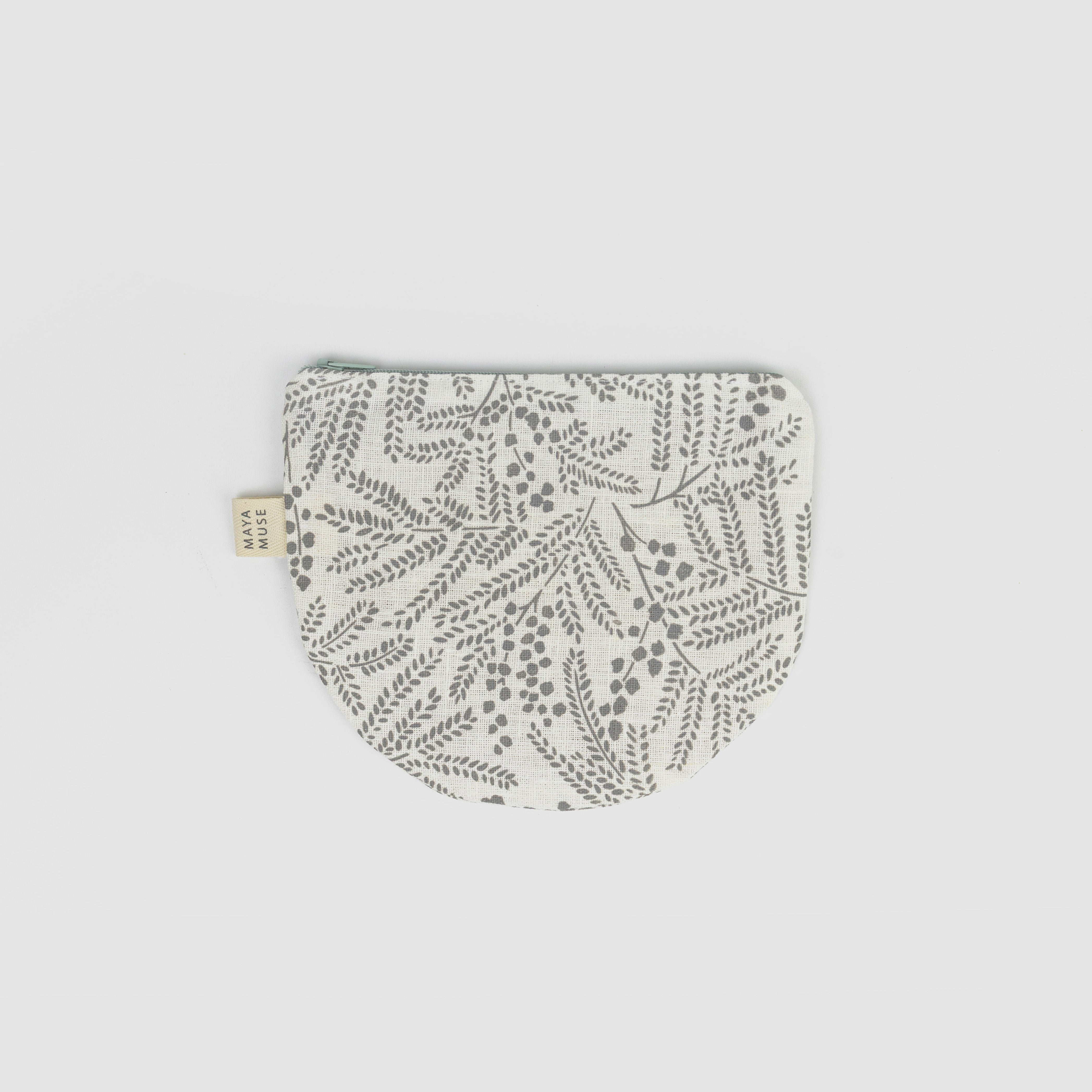 Fabric pouch with leaf pattern on a light grey background