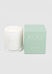 White candle with a green box labeled 'IKOU Sunrise' on a light gray background