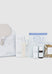 Collection of KOU wellness products including a eye mask, bottles, and a pouch on a white background