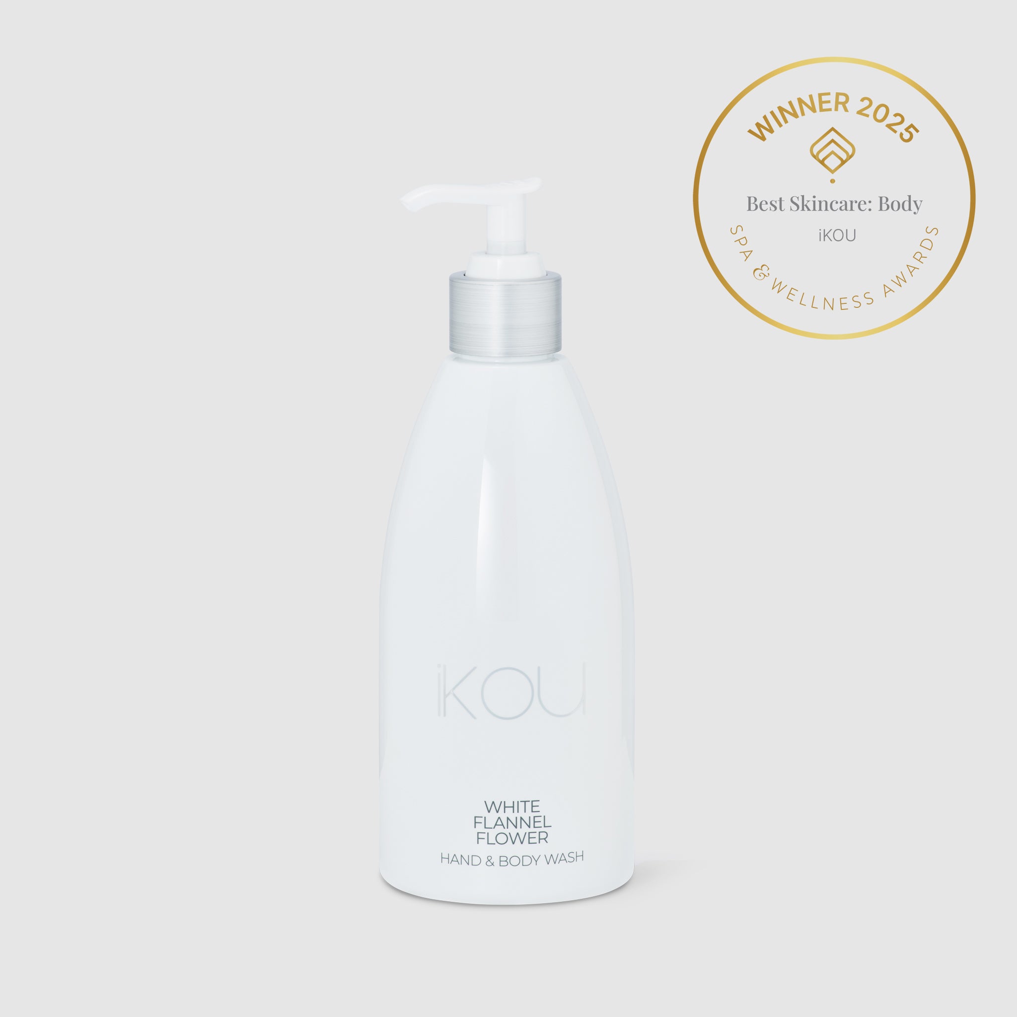 White bottle of hand and body wash with a gold award badge on a light gray background