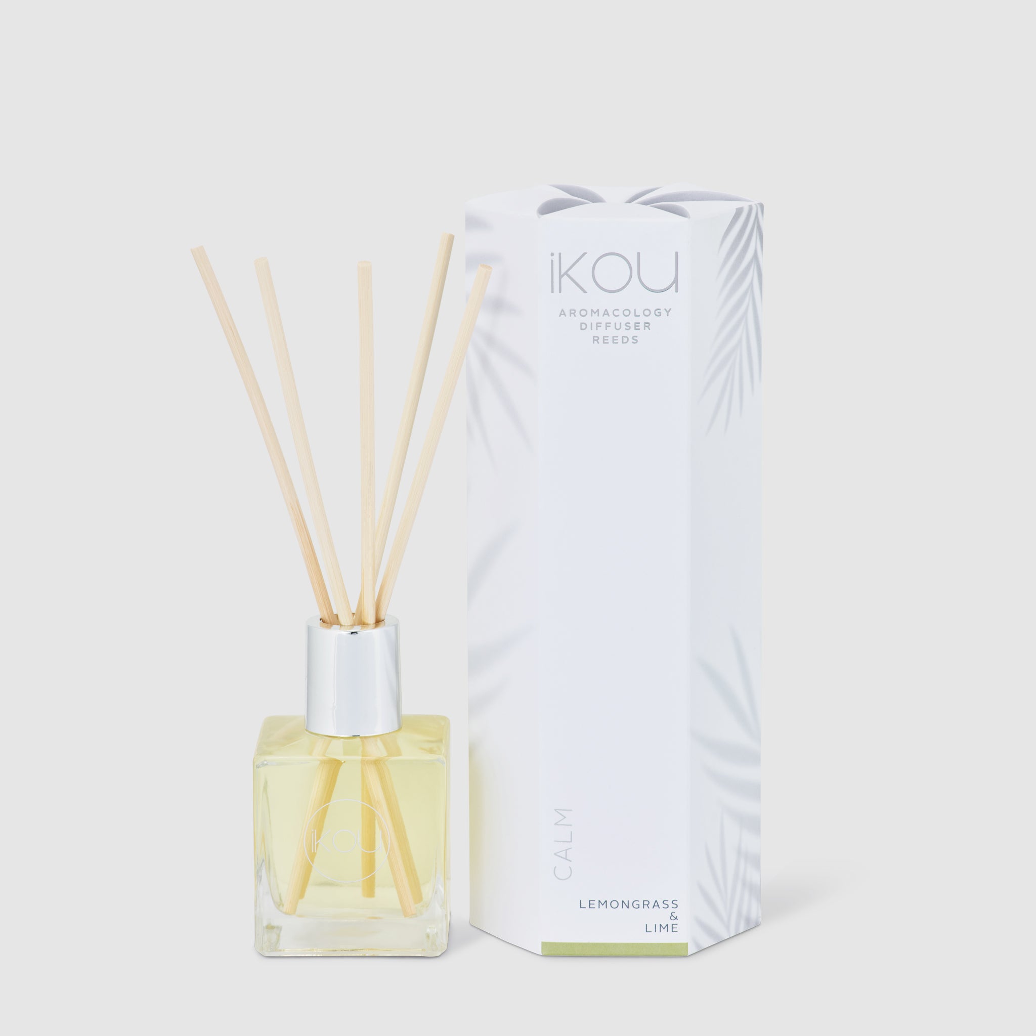 Aromatherapy diffuser with wooden sticks and packaging on a white background