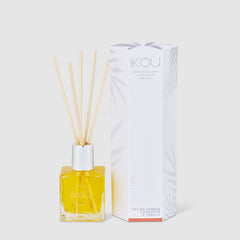 Reed diffuser with packaging on a white background