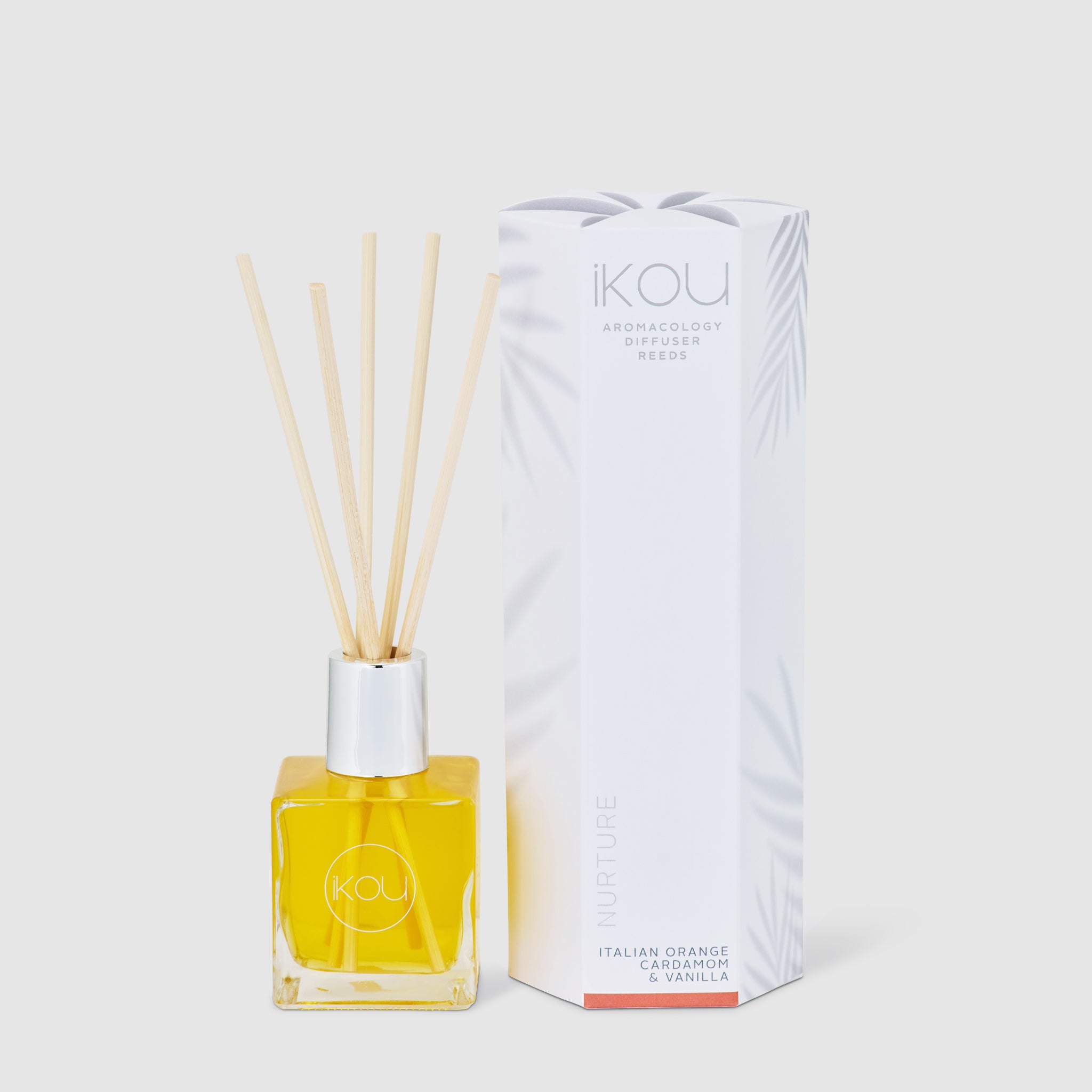 Reed diffuser with packaging on a white background