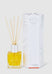 Reed diffuser with packaging on a white background