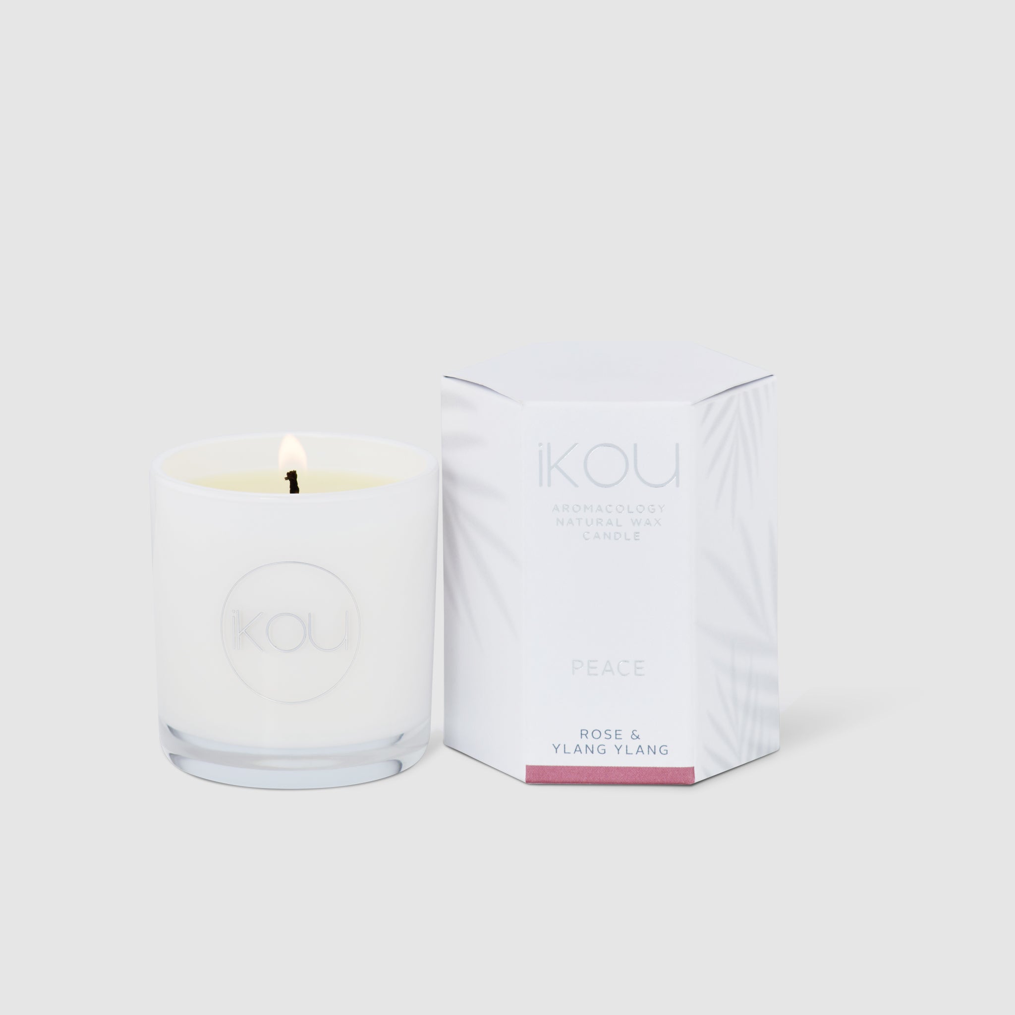 Candle with packaging labeled 'IKOU' on a white background