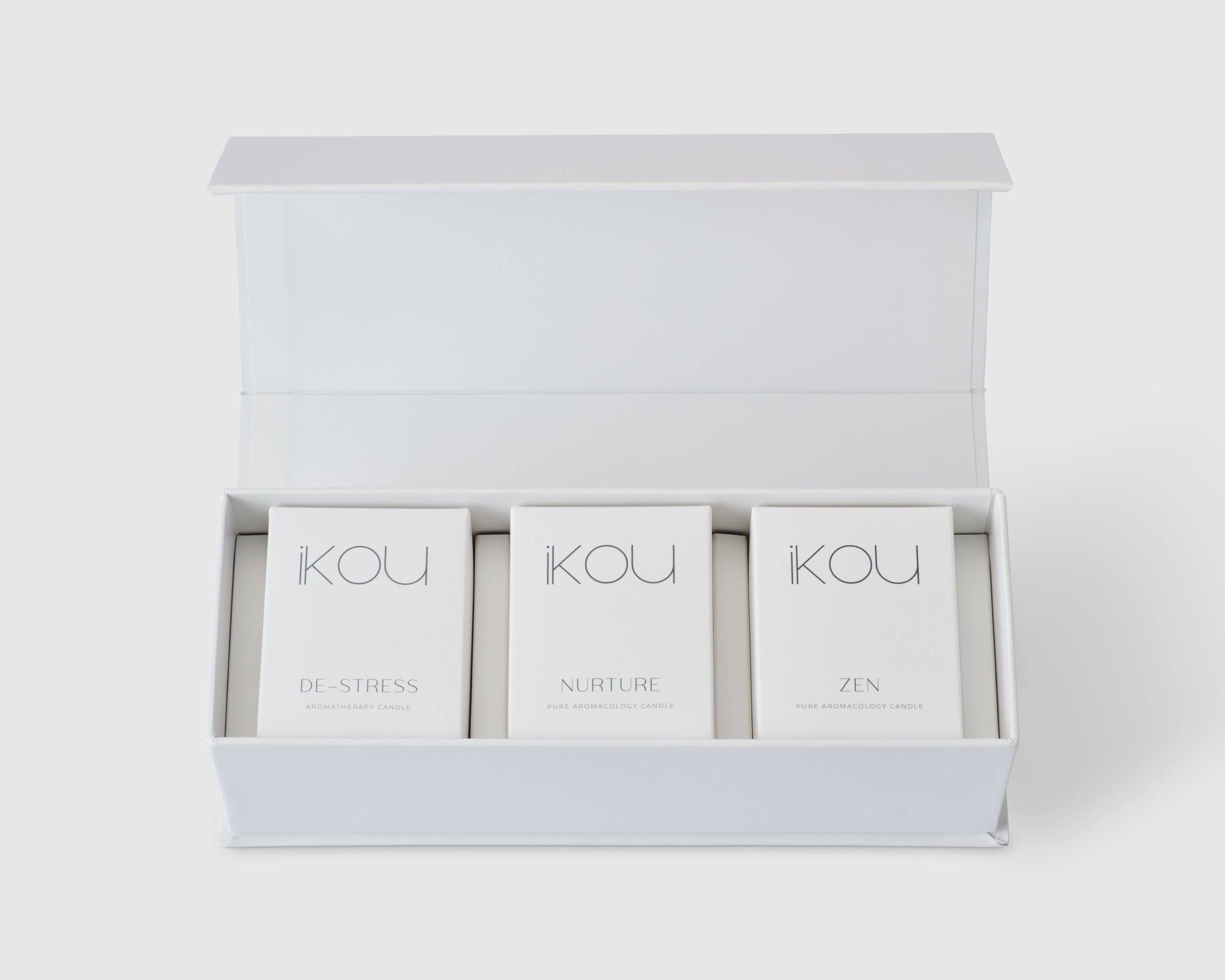 iKOU Sanctuary Candle Trio gift pack with three scented candles in elegant containers, perfect for home ambiance.
