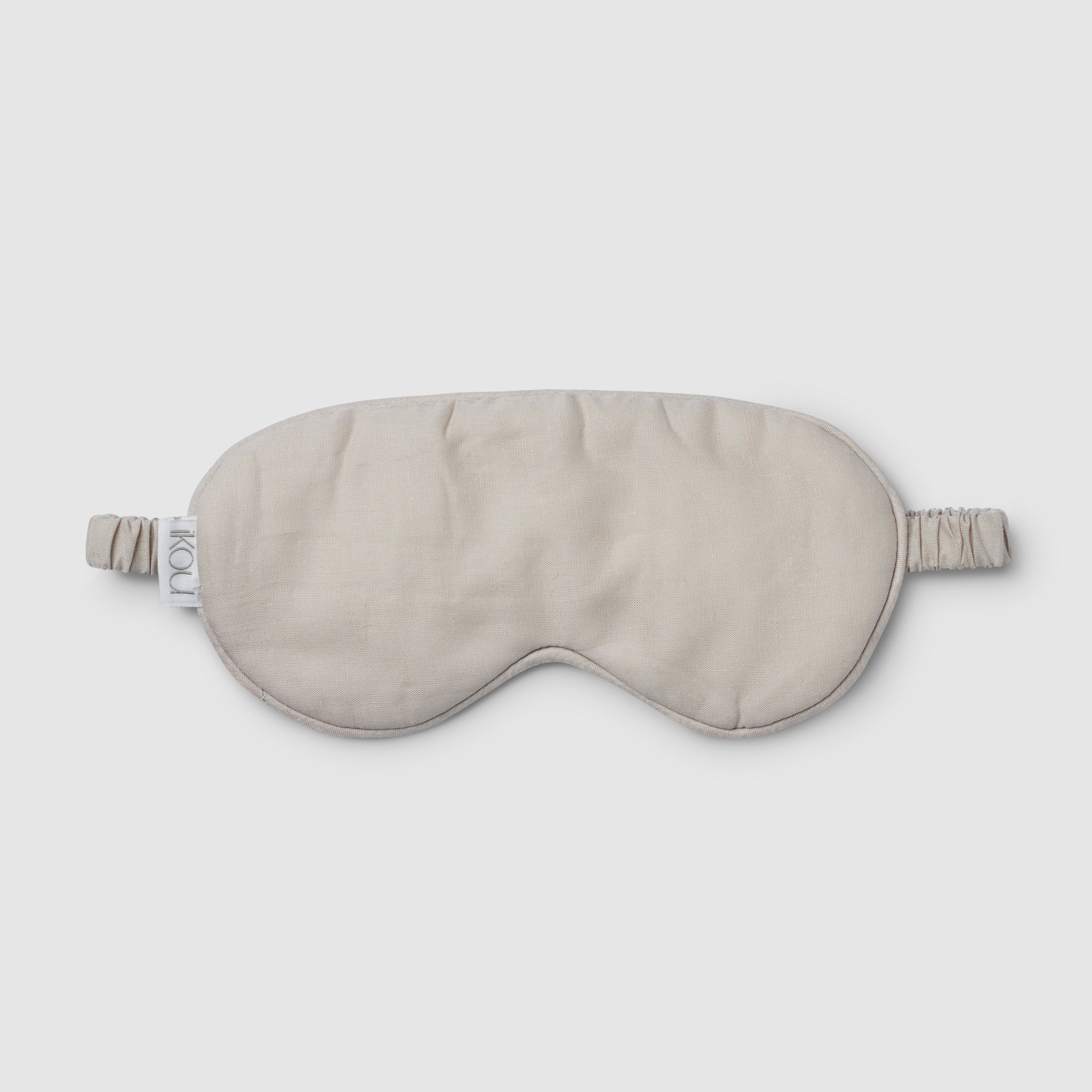 Beige sleep mask on a light gray background