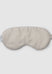 Beige sleep mask on a light gray background