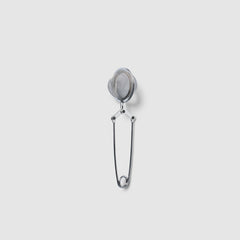 Metallic tea infuser on a light gray background