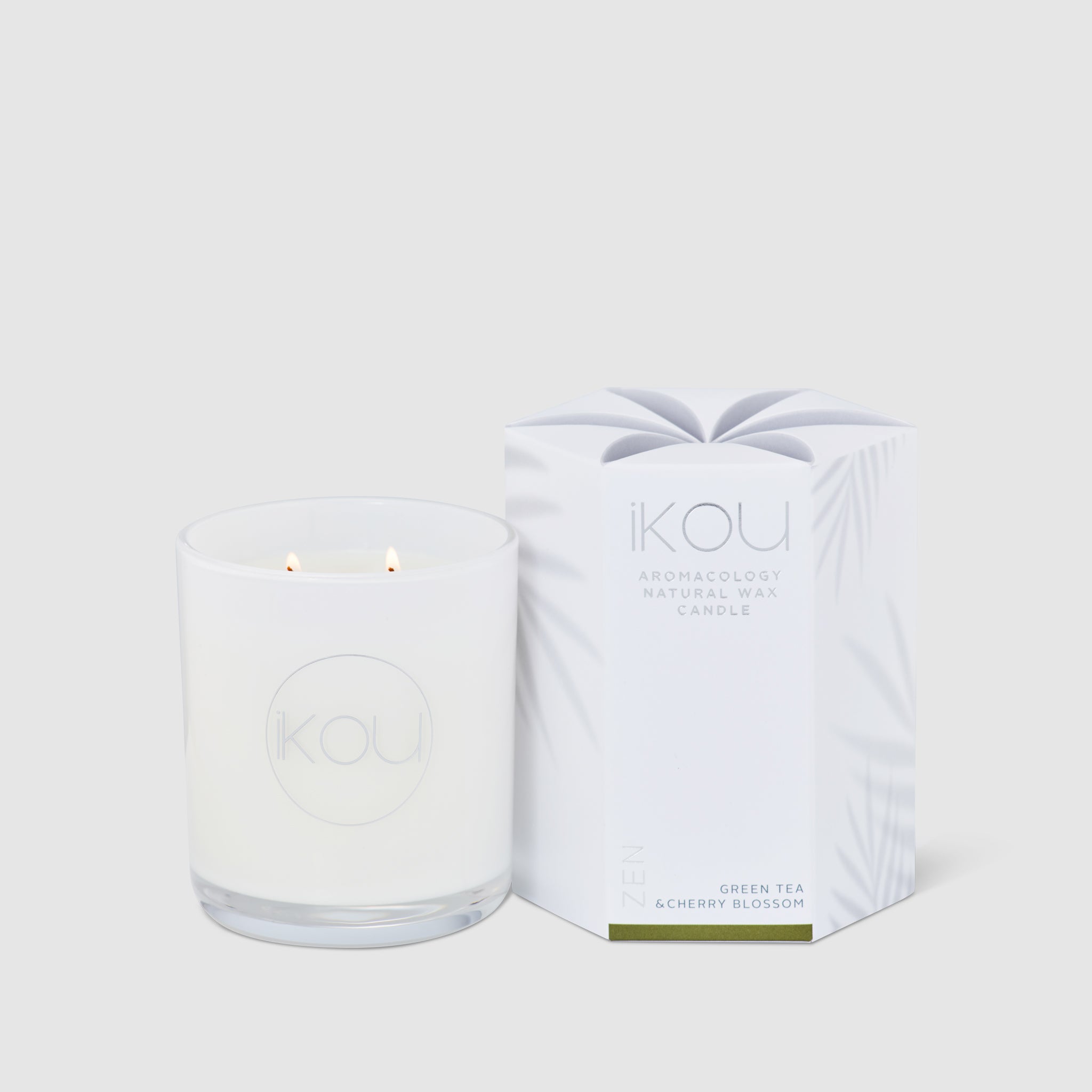White candle with 'IKOU' packaging on a white background