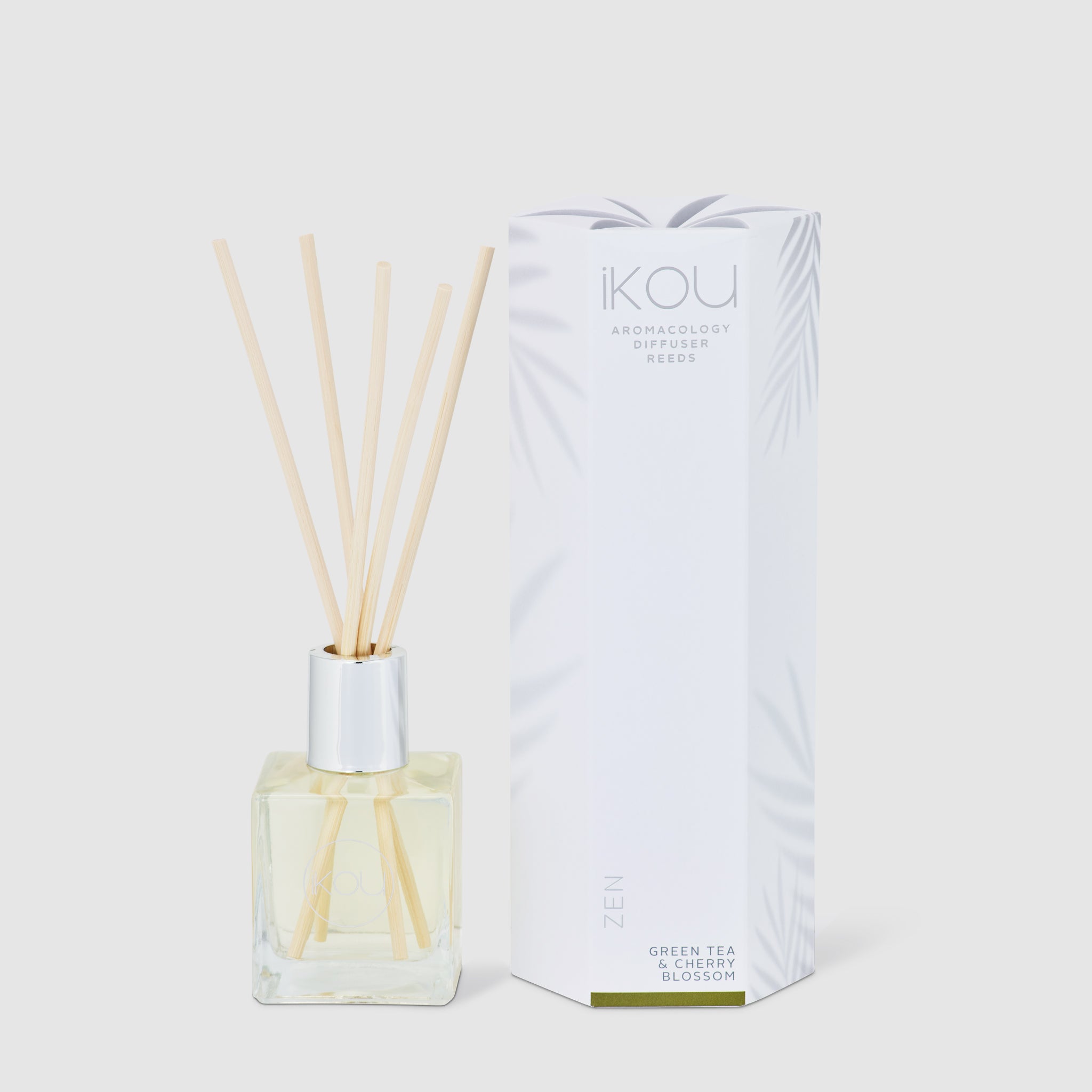 Aromatherapy diffuser with reeds and packaging on a white background