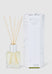 Aromatherapy diffuser with reeds and packaging on a white background